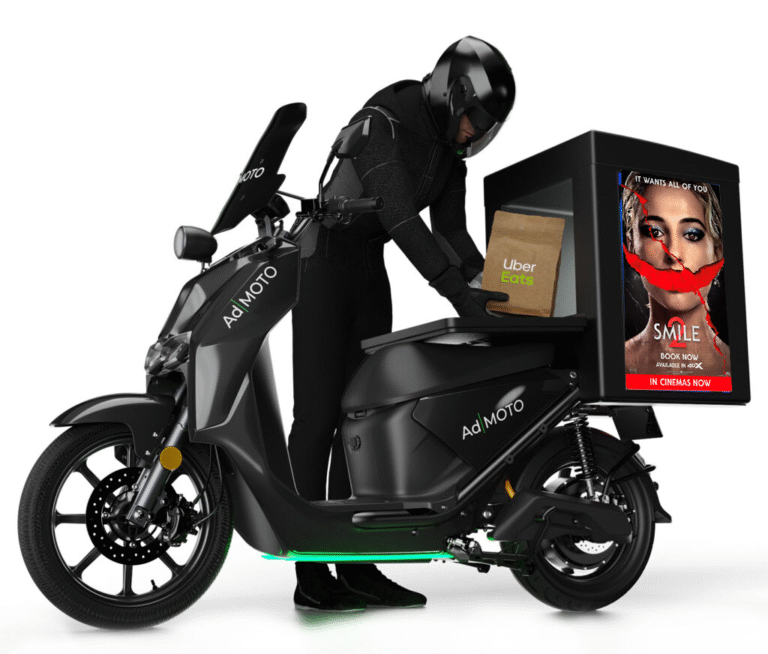 sideways Ad|moto bike of a rider putting an uber eats package into the bike, with a paramount advert on the back