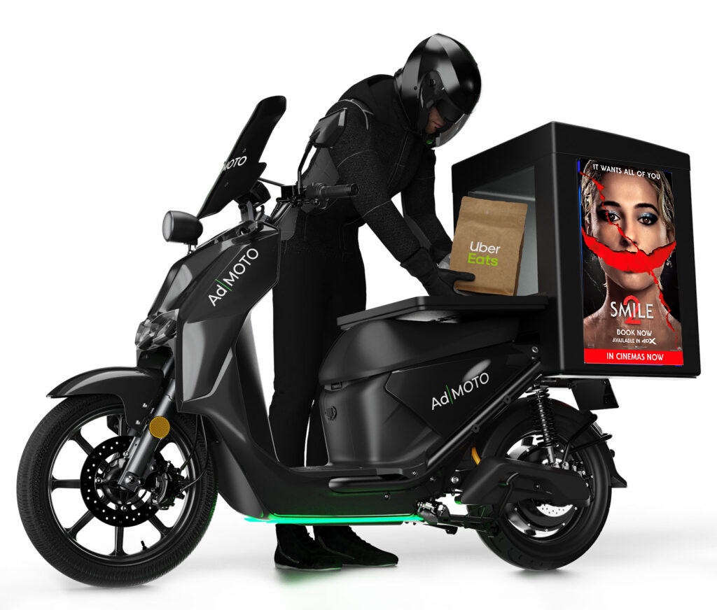 sideways Ad|moto bike of a rider putting an uber eats package into the bike, with a paramount advert on the back